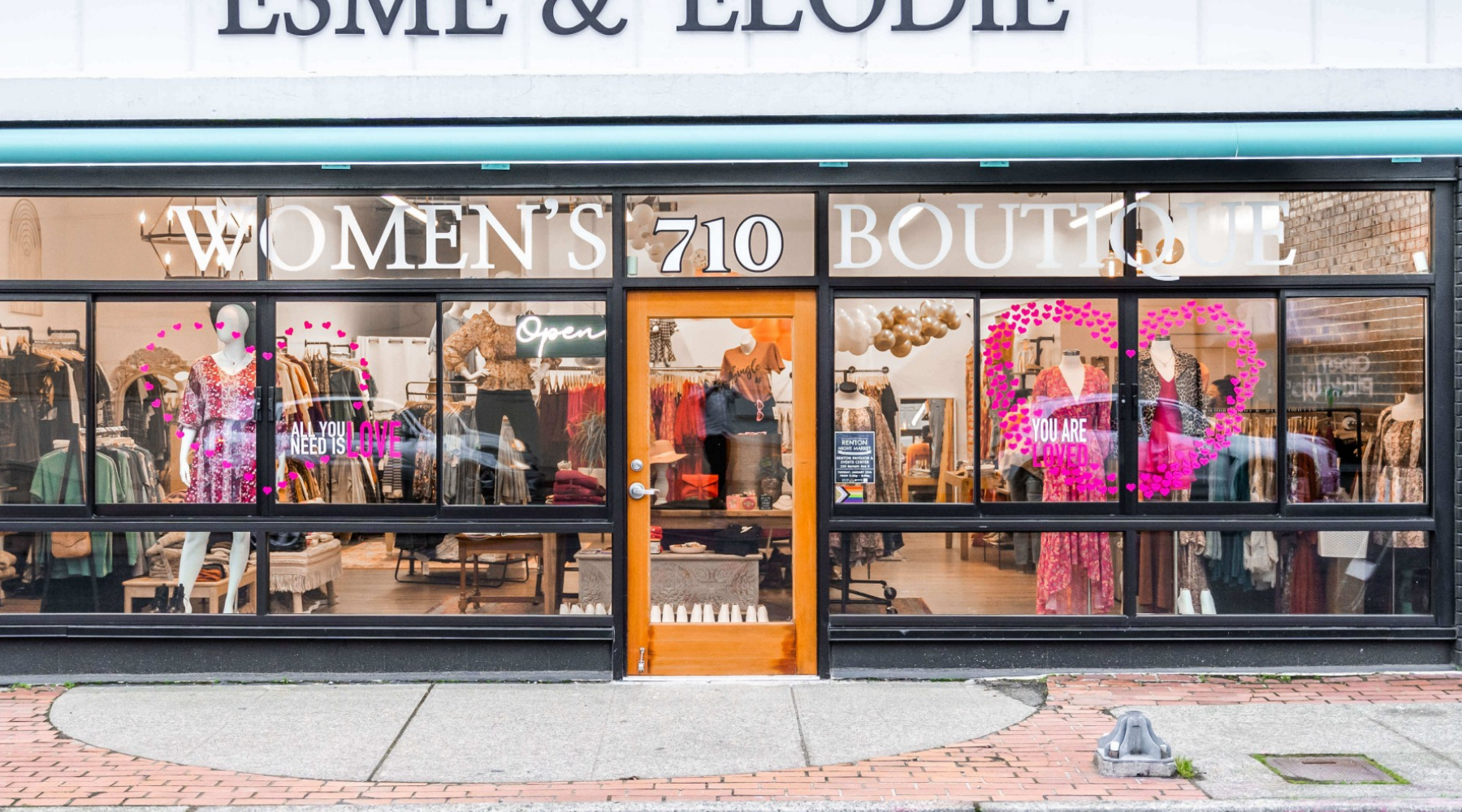 large window womens boutique in downtown renton esme and elodie womens and plus size mannequins in window with dresses