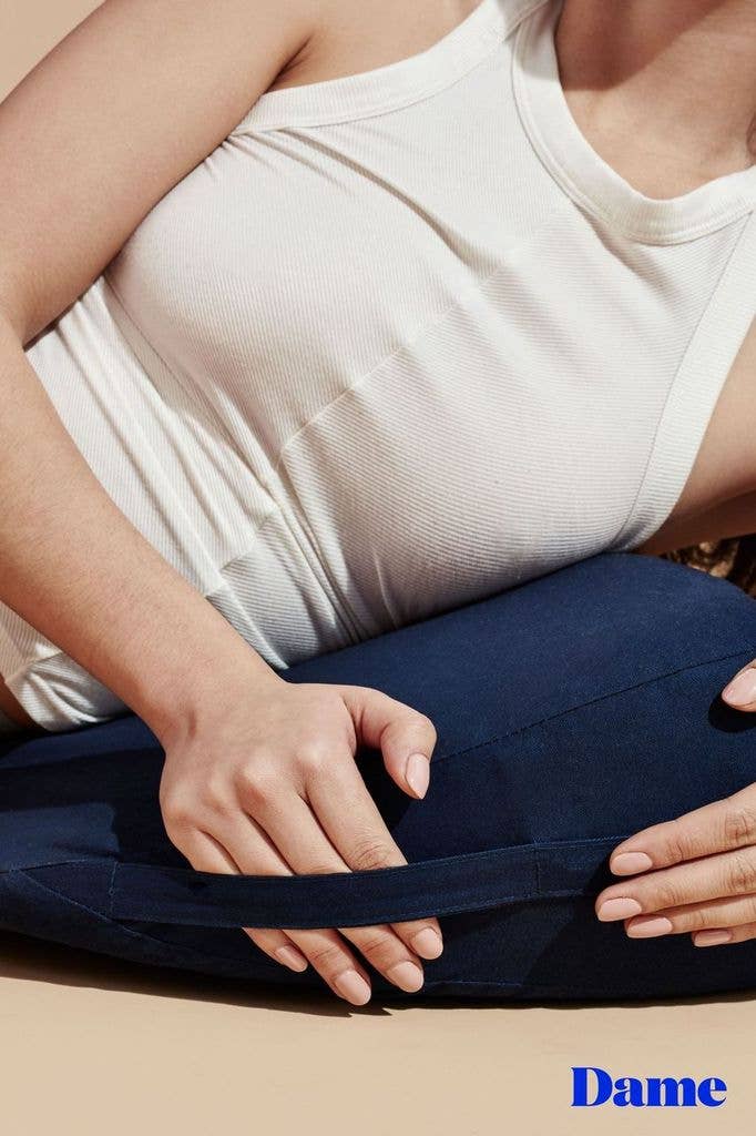 photo of woman holding the handle on the sex wedge pillow chest resting on wedge